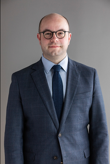 Christopher A. Noel, LL Law Firm counsel, professional headshot in navy suit with glasses