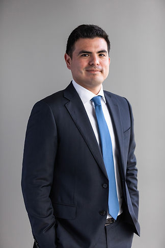 Juan J. Mendoza, LL Law Firm counsel, professional headshot in dark suit with blue tie