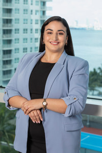 LL Law Firm new attorney, professional headshot in blue blazer against Miami skyline